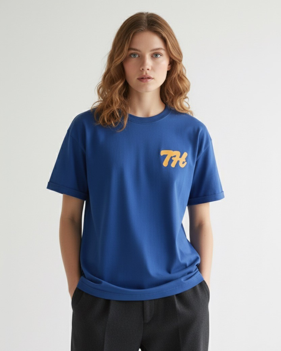 Person wearing a blue t-shirt with a yellow logo on a white background